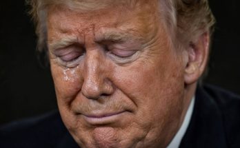 donald Trump with eyes closed and tear on cheek, dark suit, red tie, bold yellow text
