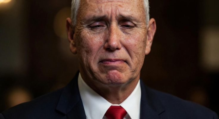man in a suit with emotional expression, dimly lit setting