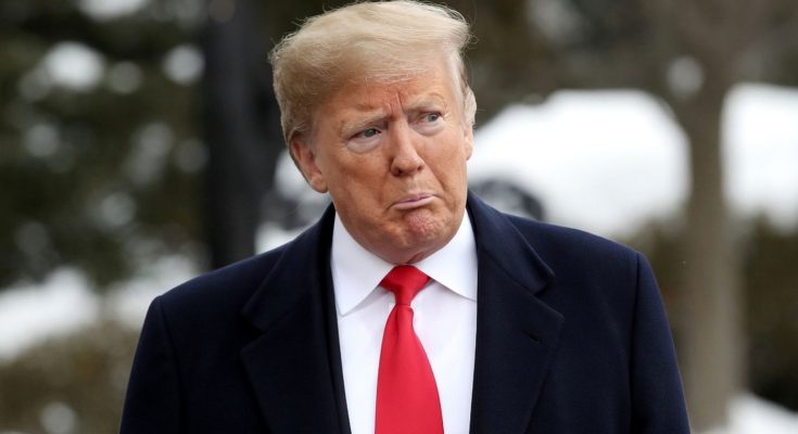 man in suit with red tie in an outdoor setting