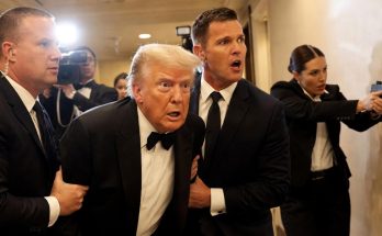 security personnel escorting a concerned man through hallway