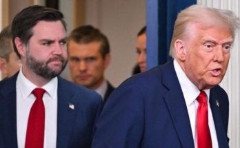 donald Trump speaking in foreground with JD Vance behind him, bold headline reads JUST
