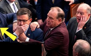 politician silenced by colleague in crowded room during debate