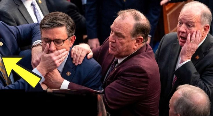 politician silenced by colleague in crowded room during debate