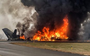 burning aircraft engulfed in flames on airport runway
