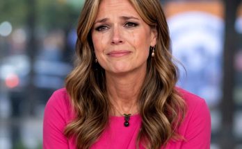 woman in pink top with tearful expression indoors