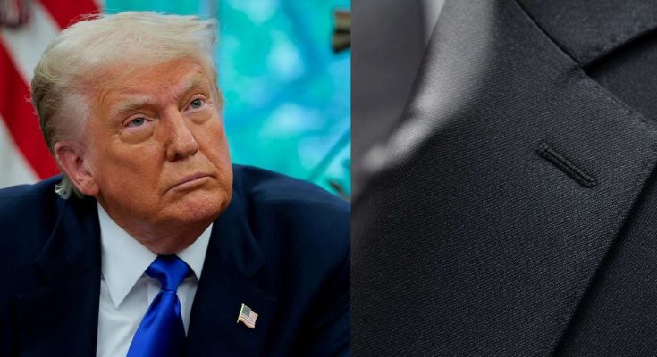 leader in blue suit with American flag pin, serious expression