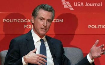 gavin Newsom seated at POLITICO event with USA Journal logo, viral video headline about