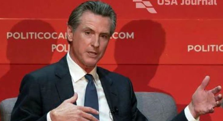 gavin Newsom seated at POLITICO event with USA Journal logo, viral video headline about
