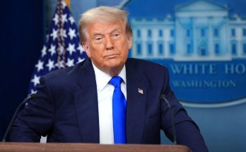 donald Trump stands at White House podium with American flag and presidential seal