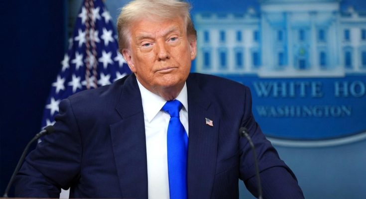 donald Trump stands at White House podium with American flag and presidential seal