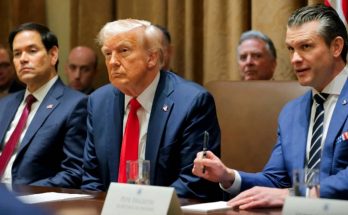 donald Trump seated at conference table with Marco Rubio and Pete Hegseth during cabinet